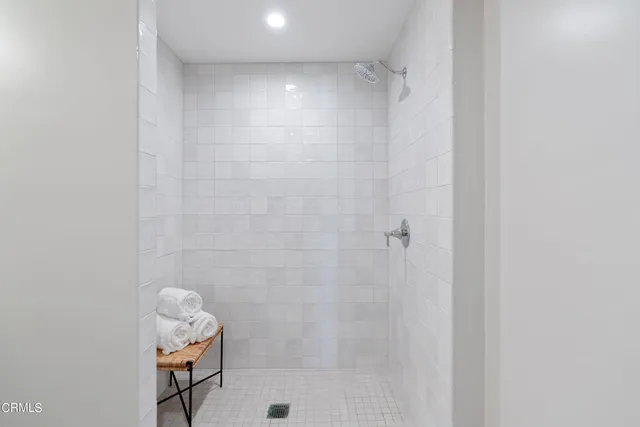 a floor view with two painting on the wall and a large mirror