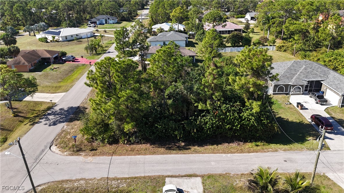 a aerial view of a house with a yard basket ball court and outdoor seating