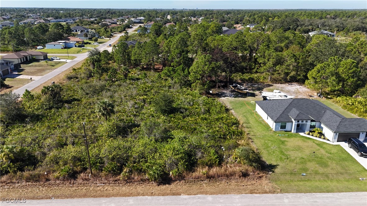 800 West 9th Street Lehigh Acres, FL 33972 - Photo 5 of 14 an aerial view of residential houses with outdoor space and trees