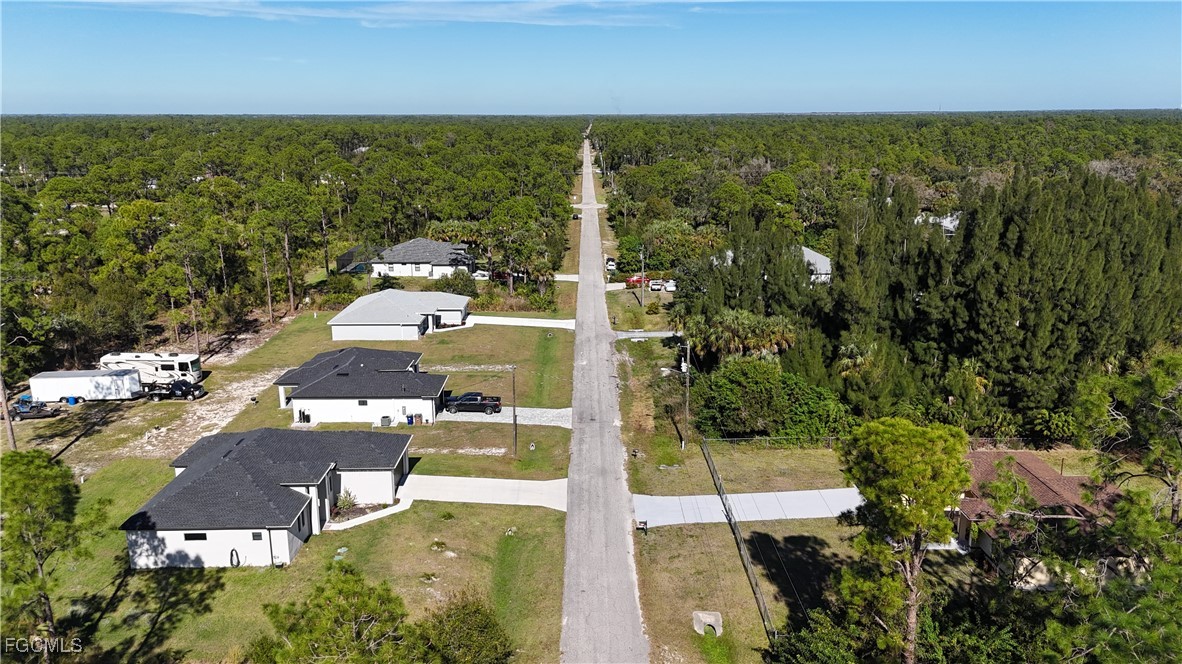 800 West 9th Street Lehigh Acres, FL 33972 - Photo 6 of 14 an aerial view of residential houses with outdoor space and trees