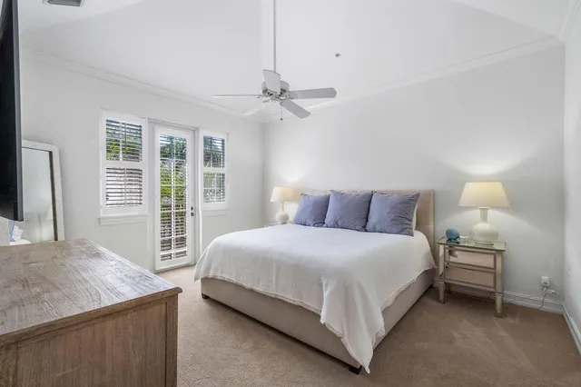 a bedroom with a bed chandelier and a window