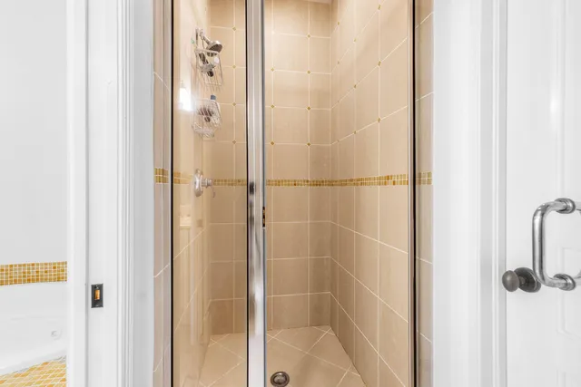 a bathroom with a glass shower door