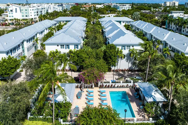 an aerial view of multiple houses with yard