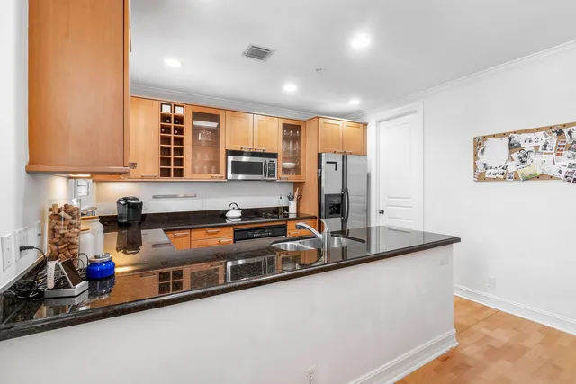 a kitchen with stainless steel appliances granite countertop a sink stove and cabinets