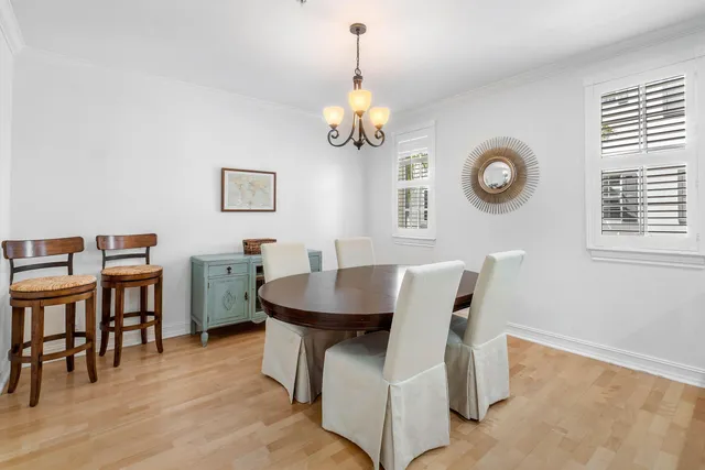 a view of a dining room with furniture and a chandelier