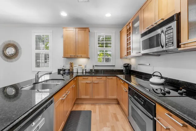 a kitchen with stainless steel appliances a sink stove and microwave