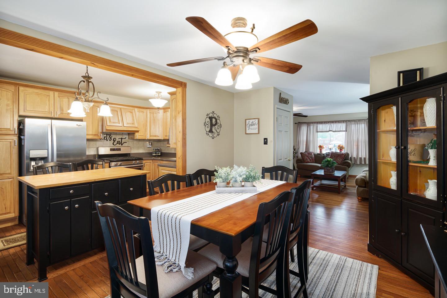 12482 Balston Road Philadelphia, PA 19154 - Photo 12 of 30 a kitchen with a dining table chairs cabinets and stainless steel appliances