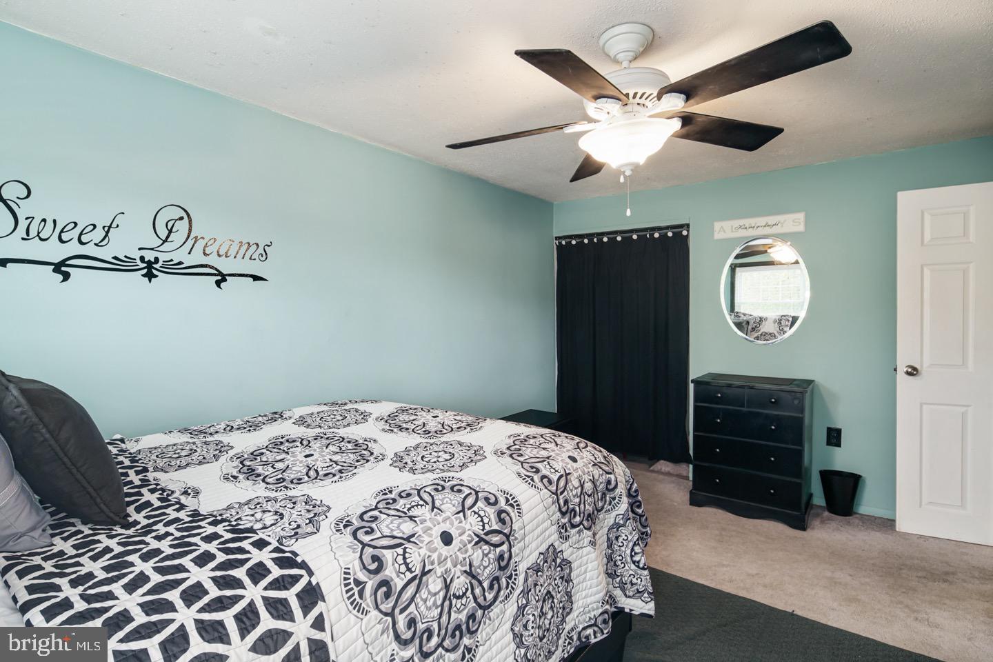 12482 Balston Road Philadelphia, PA 19154 - Photo 29 of 30 a bedroom with a bed and a chandelier