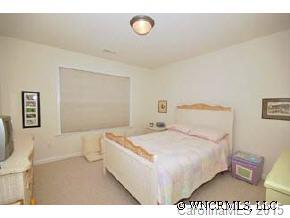 273 Wildbriar Road Fletcher, NC 28732 - Photo 11 of 11 a bedroom with a bed and a table