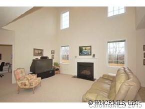 273 Wildbriar Road Fletcher, NC 28732 - Photo 6 of 11 a living room with furniture a fireplace and a flat screen tv