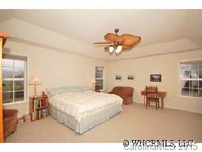273 Wildbriar Road Fletcher, NC 28732 - Photo 9 of 11 a bedroom with a bed and a table with closet