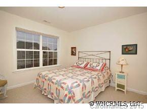 273 Wildbriar Road Fletcher, NC 28732 - Photo 10 of 11 a bedroom with a bed and a large window