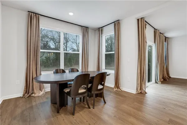 a view of a dining room with furniture and wooden floor