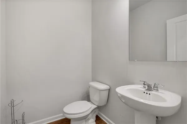 a bathroom with a sink a toilet and mirror