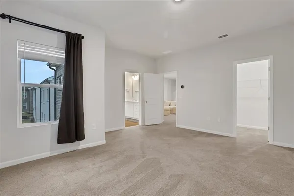 an empty room with windows and closet