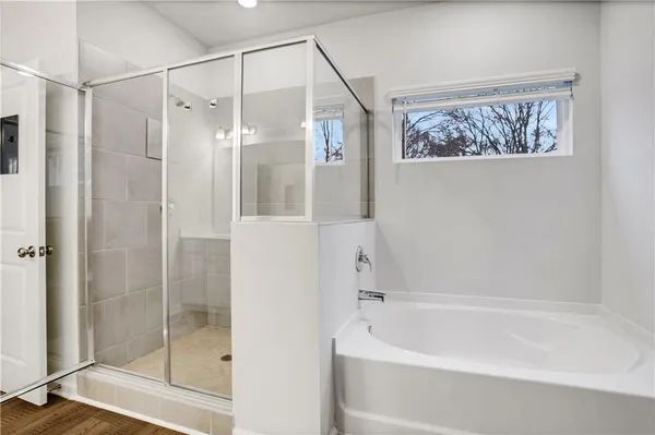 a bathroom with a bathtub and a shower