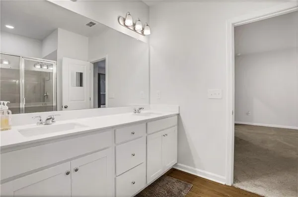 a bathroom with a double vanity sink and mirror