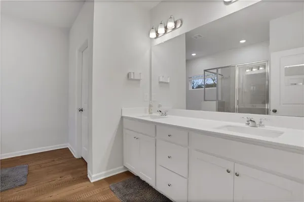 a bathroom with a double vanity sink and mirror
