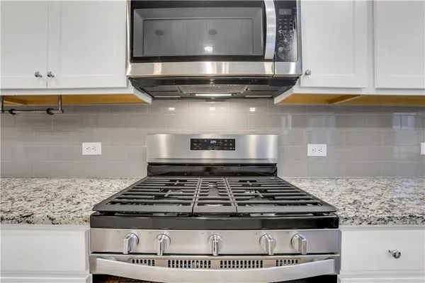 a stove top oven sitting inside of a kitchen