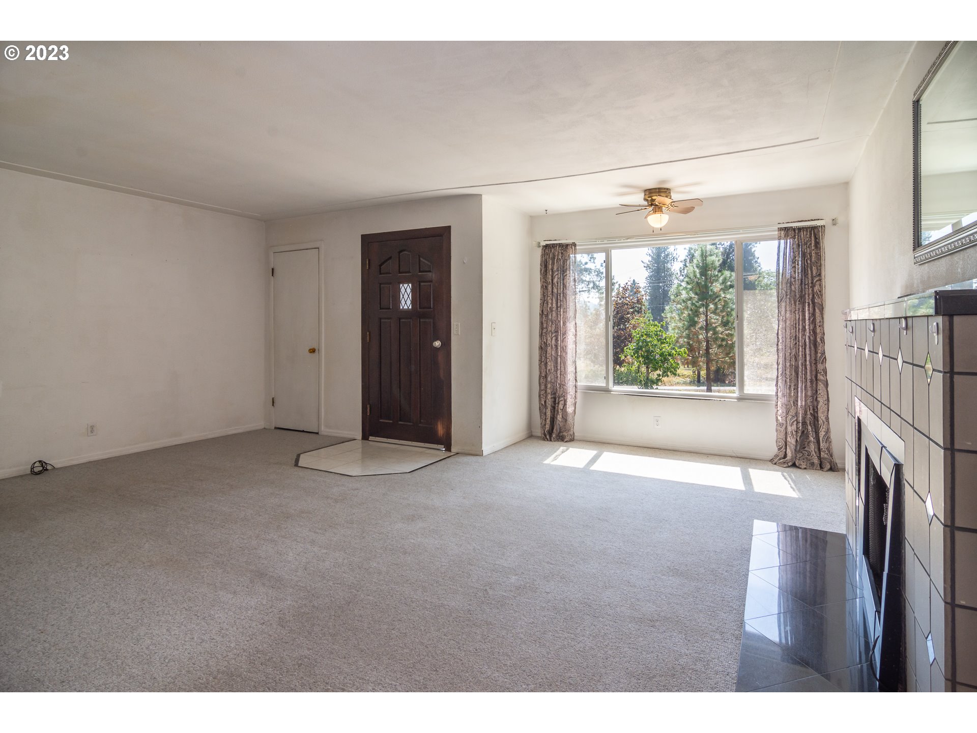 959 Doerner Road Roseburg, OR 97471 - Photo 19 of 40 a view of an empty room with a fireplace and a window
