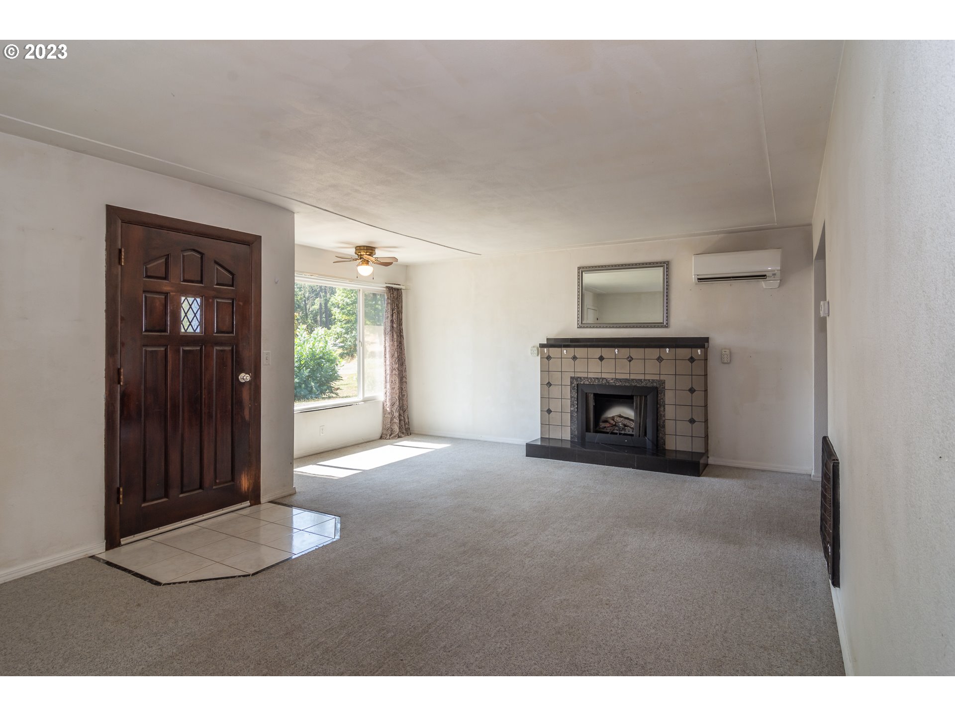 959 Doerner Road Roseburg, OR 97471 - Photo 20 of 40 a view of an empty room with a fireplace and a window