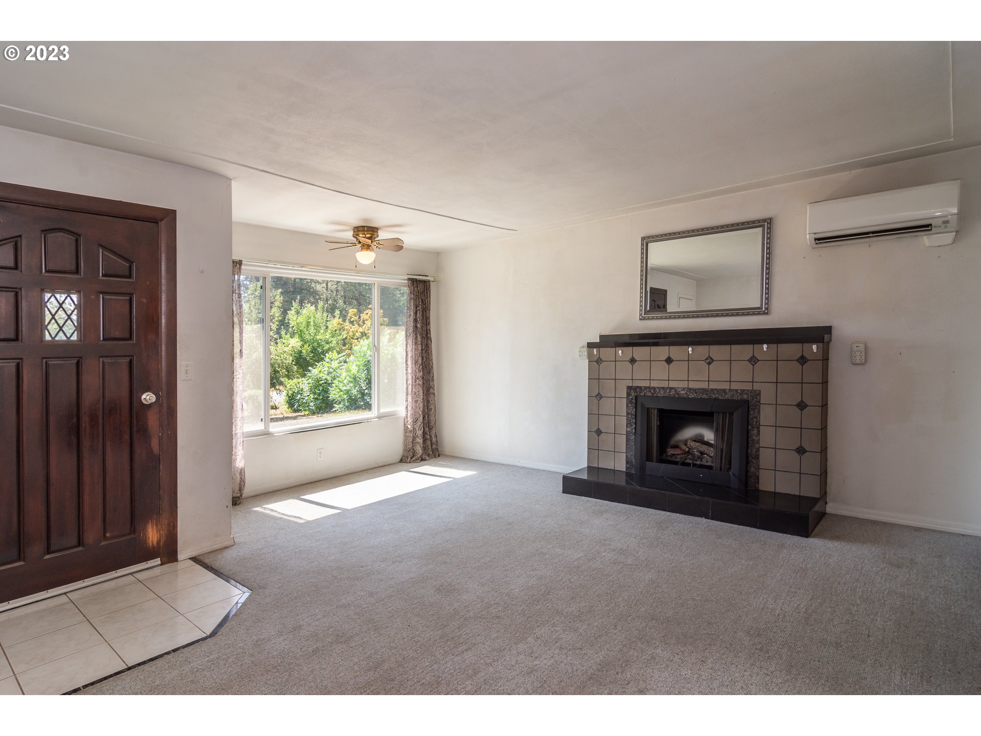 959 Doerner Road Roseburg, OR 97471 - Photo 21 of 40 a view of an empty room with window and fire place