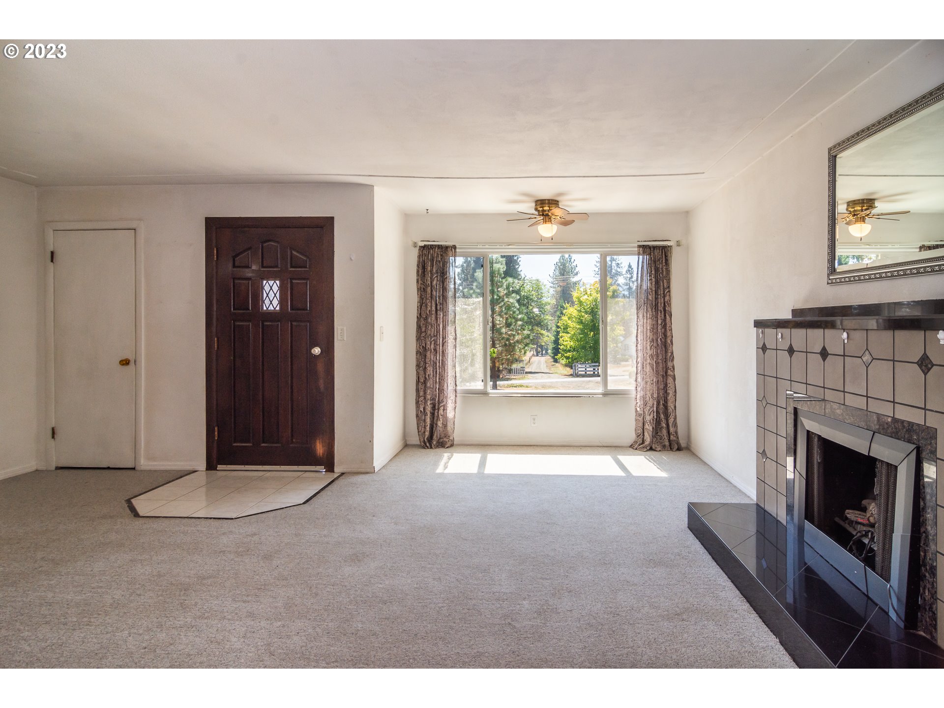 959 Doerner Road Roseburg, OR 97471 - Photo 23 of 40 a view of an empty room with a fireplace and a window