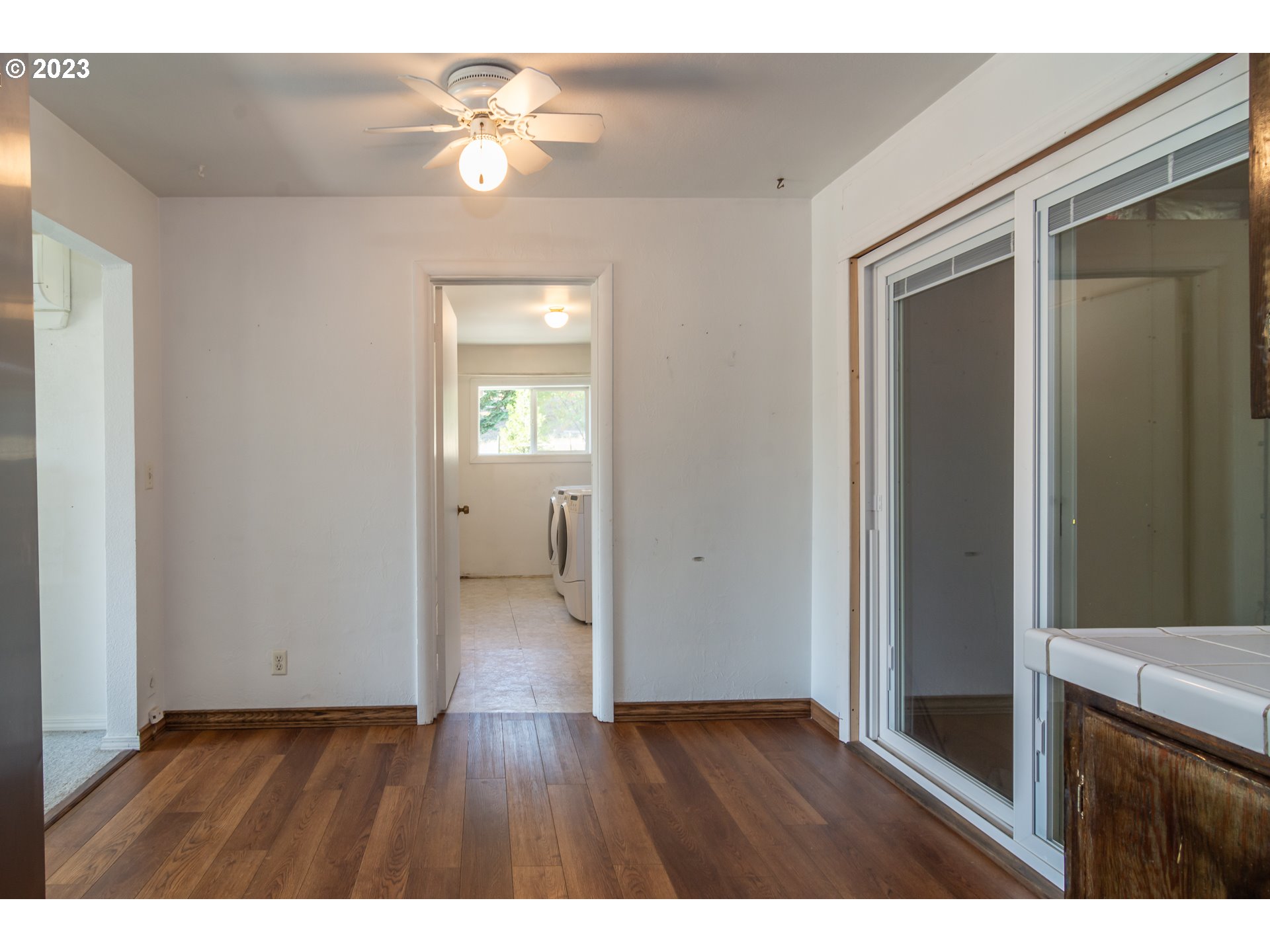 959 Doerner Road Roseburg, OR 97471 - Photo 27 of 40 a view interior of a house wooden floor a chandelier fan and windows