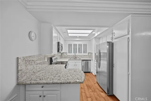 a kitchen with counter top space cabinets and stainless steel appliances