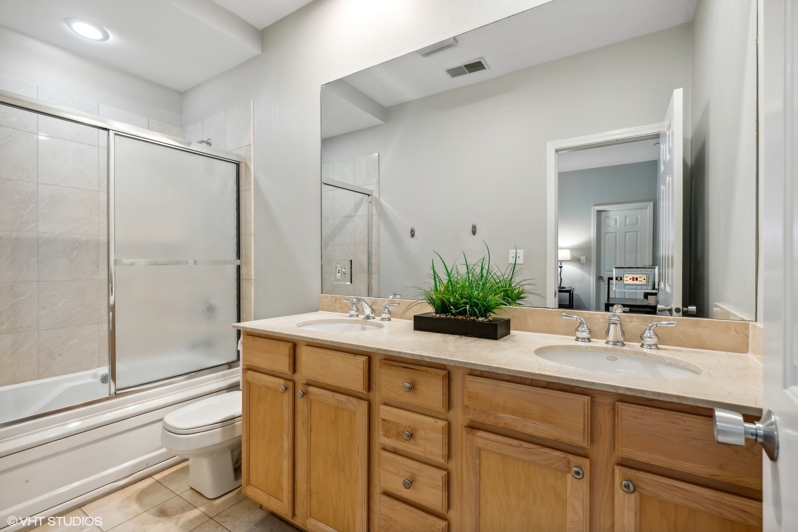 3818 North Clark Street, Unit 1S Chicago, IL 60613 - Photo 20 of 22 a bathroom with a granite countertop sink a toilet and mirror