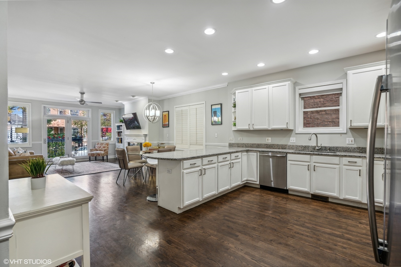 3818 North Clark Street, Unit 1S Chicago, IL 60613 - Photo 7 of 22 a kitchen with sink cabinets and wooden floor
