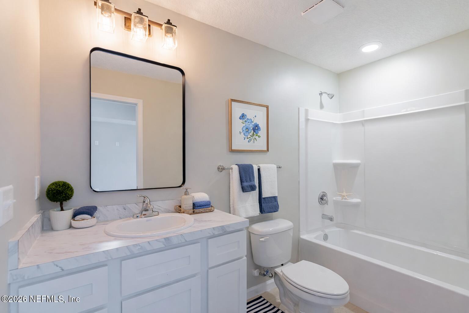 6202 Furman Avenue Keystone Heights, FL 32656 - Photo 17 of 24 a bathroom with a granite countertop sink toilet and shower