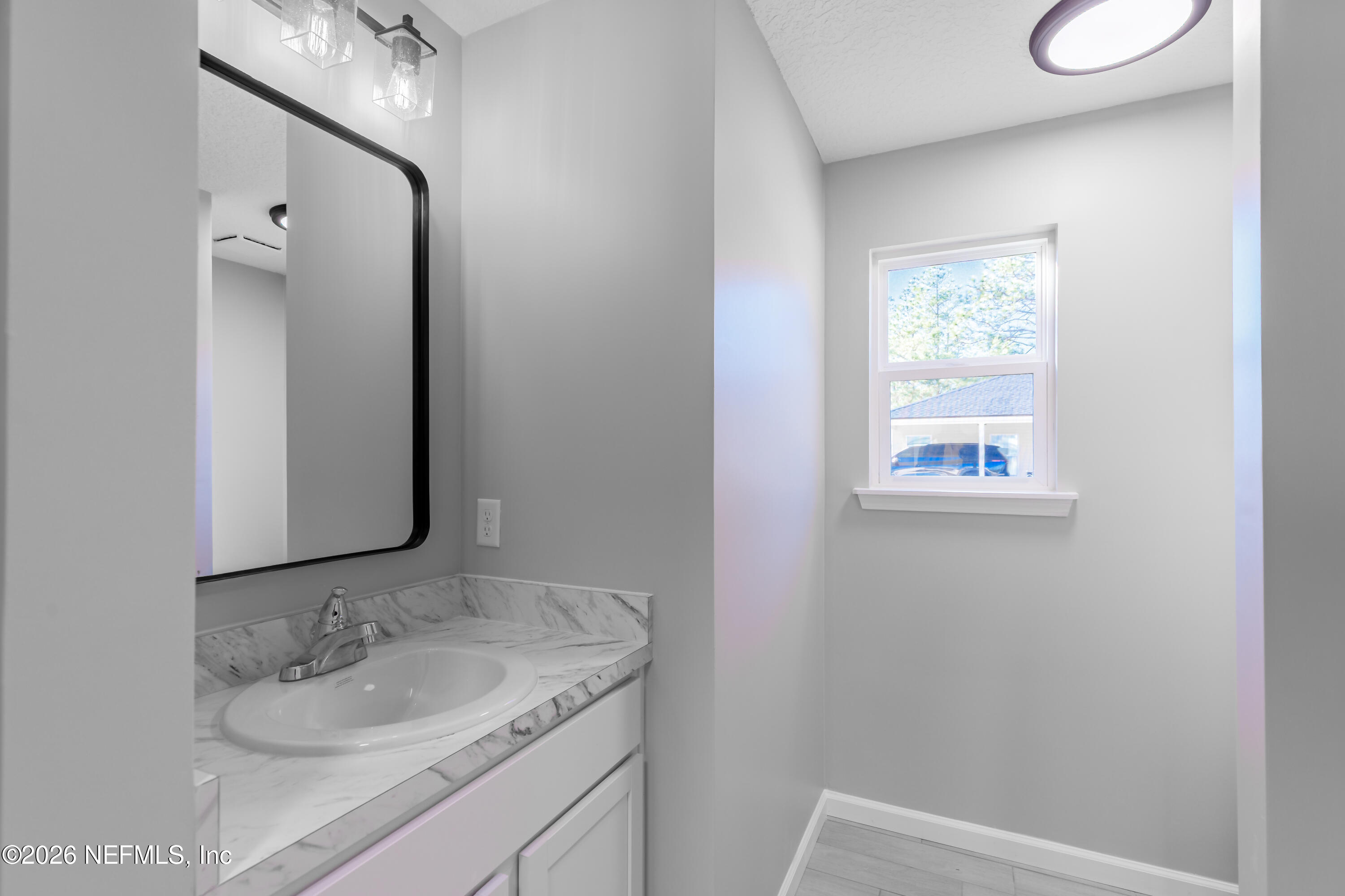 6202 Furman Avenue Keystone Heights, FL 32656 - Photo 20 of 24 a bathroom with a granite countertop sink and a mirror