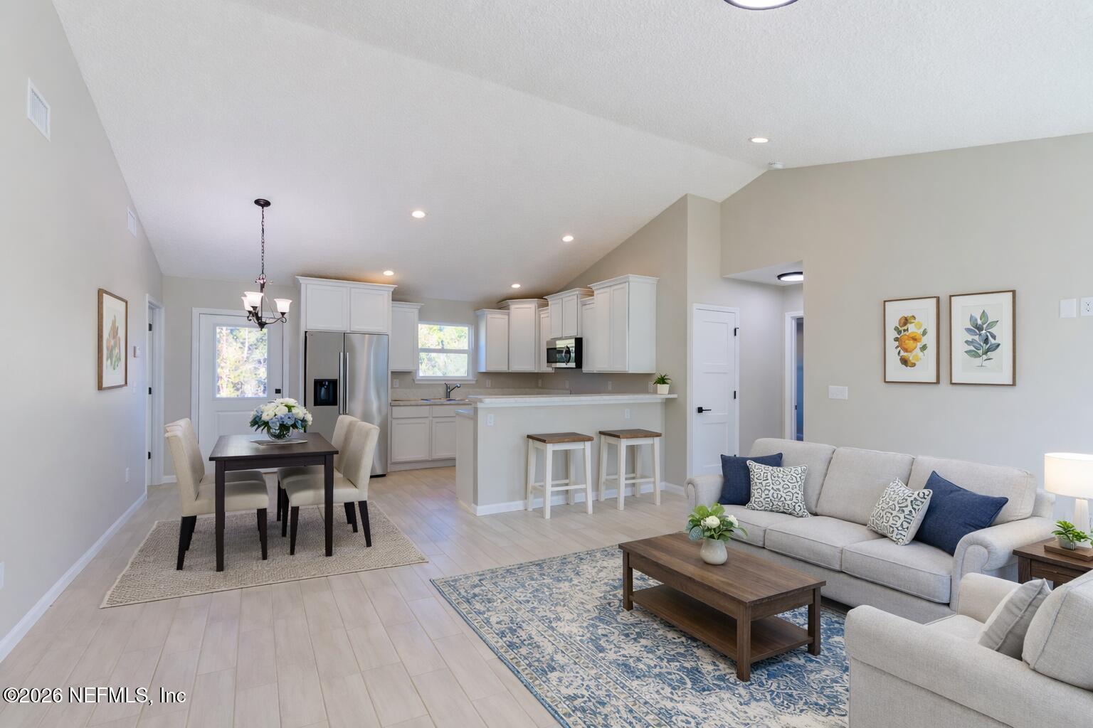 6202 Furman Avenue Keystone Heights, FL 32656 - Photo 8 of 24 a living room with furniture dining table a rug and a dining table with kitchen view