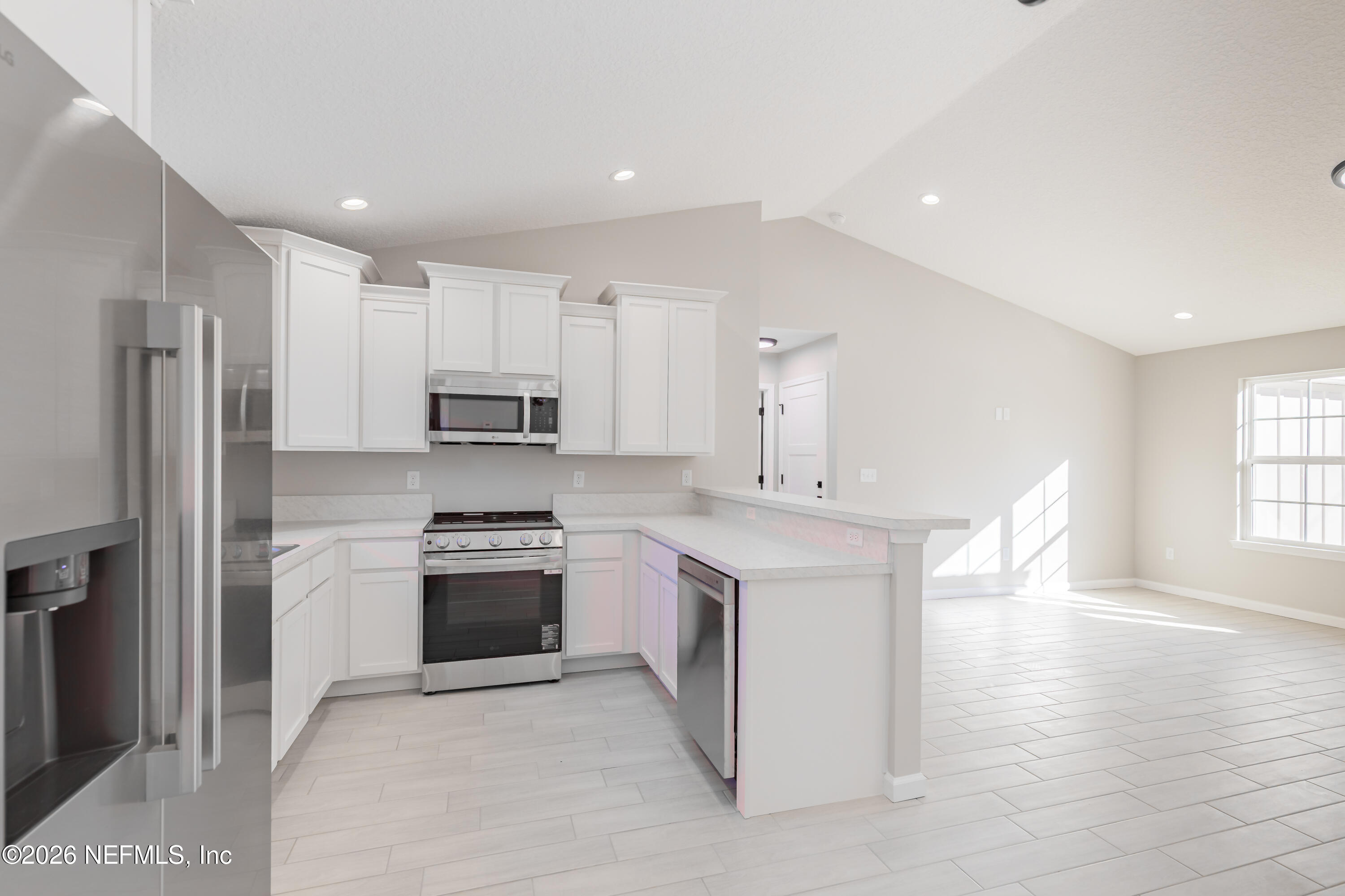 6202 Furman Avenue Keystone Heights, FL 32656 - Photo 10 of 20 a kitchen with stainless steel appliances granite countertop a stove and a refrigerator