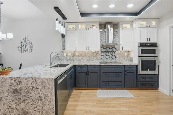 a bathroom with a granite countertop double vanity sink and a mirror
