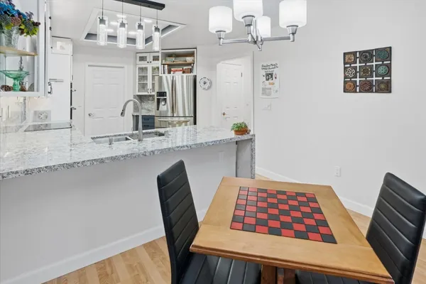 a view of kitchen with cabinets and window