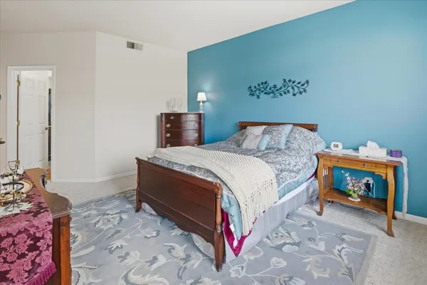 a bedroom with a bed and a couch