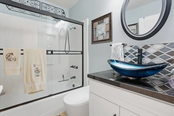a bathroom with a toilet a sink and a mirror