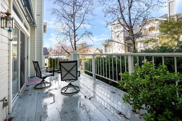 a view of balcony with wooden floor and seating space