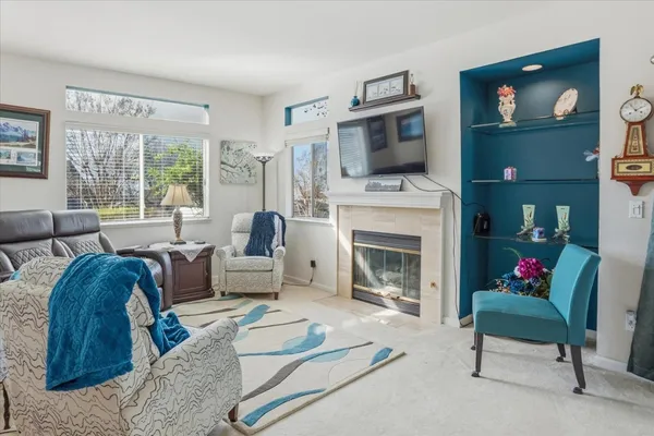 a living room with furniture fireplace and flat screen tv