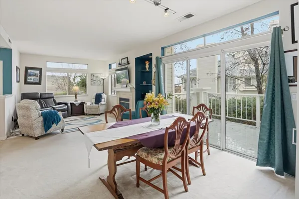 a dining room with furniture and wooden floor