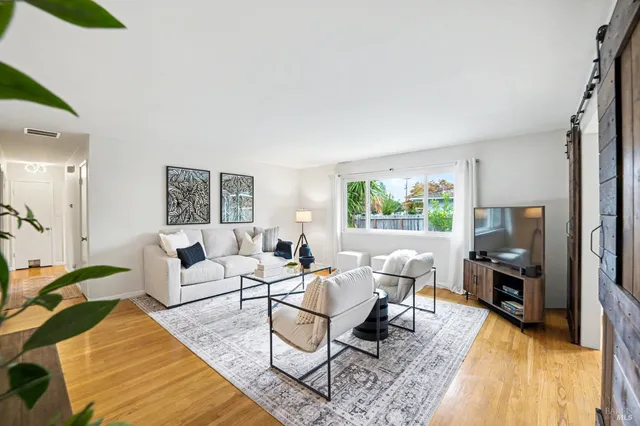 a living room with furniture and a flat screen tv