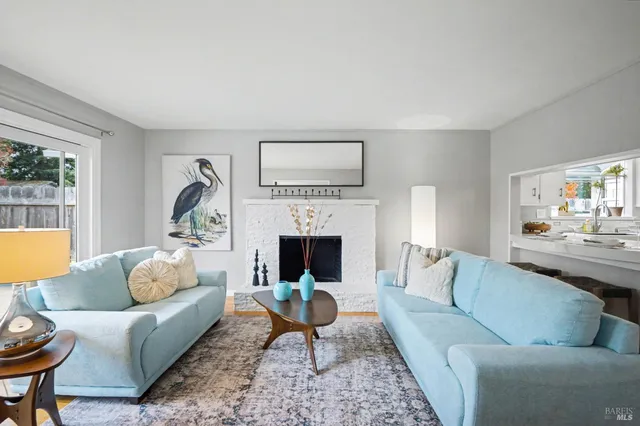 a living room with furniture a fireplace and a table