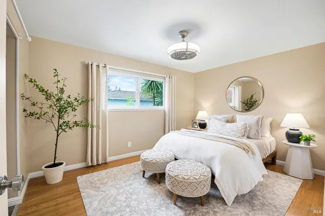 a bedroom with a bed and a potted plant