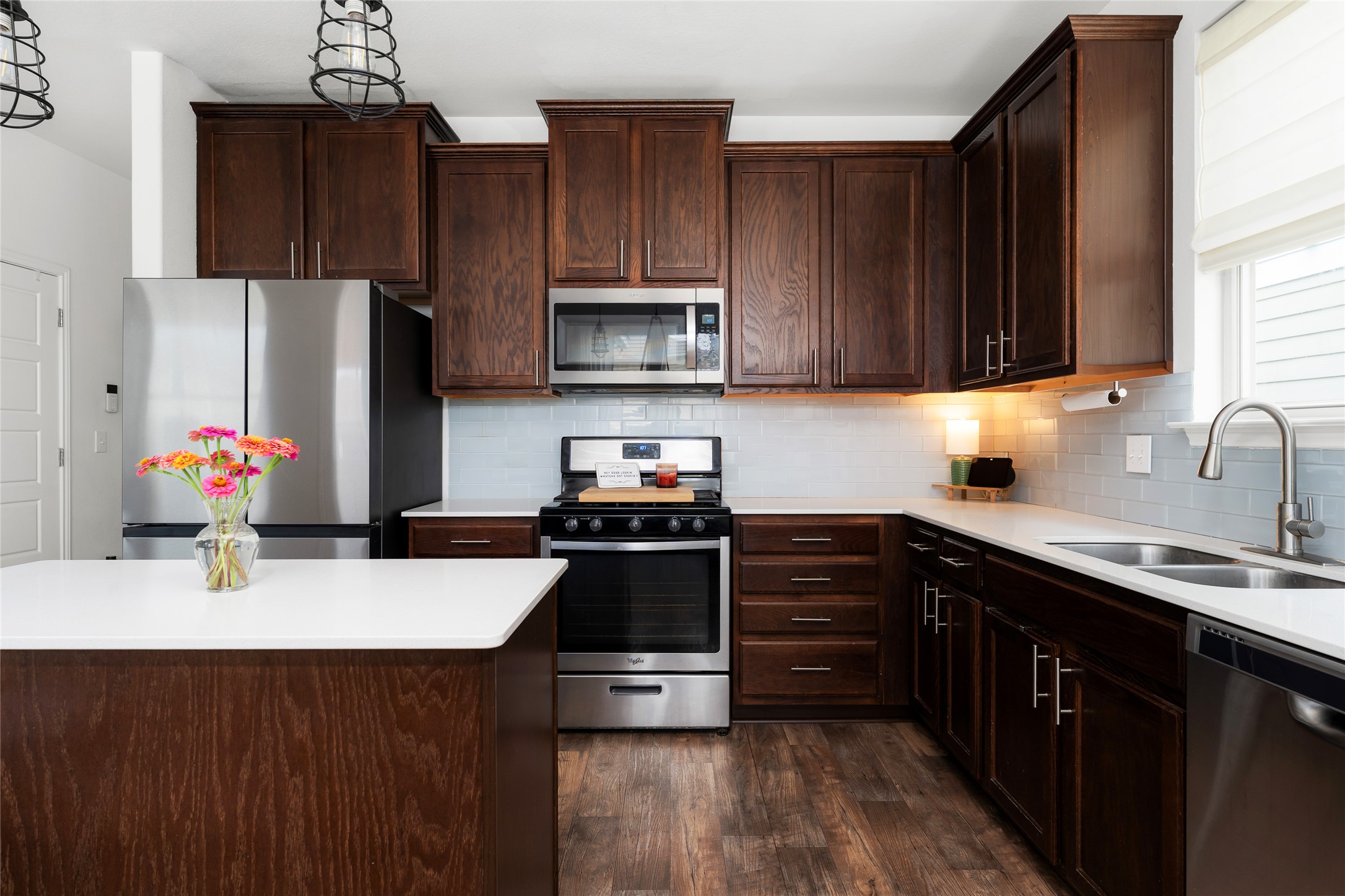 249 Wapiti Road Buda, TX 78610 - Photo 9 of 21 Culinary dreams come alive in this kitchen featuring abundant rich wood cabinetry and premium stainless steel appliances.