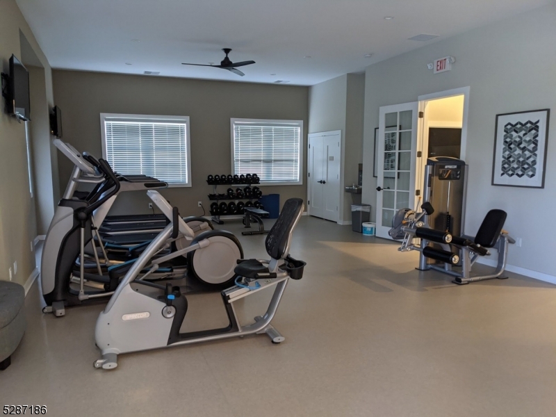 a room with gym equipment and windows