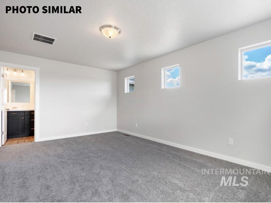 925 Twilight Weiser, ID 83672 - Photo 17 of 31 Spacious room featuring neutral carpeting, light-toned walls, and a ceiling-mounted flush light fixture