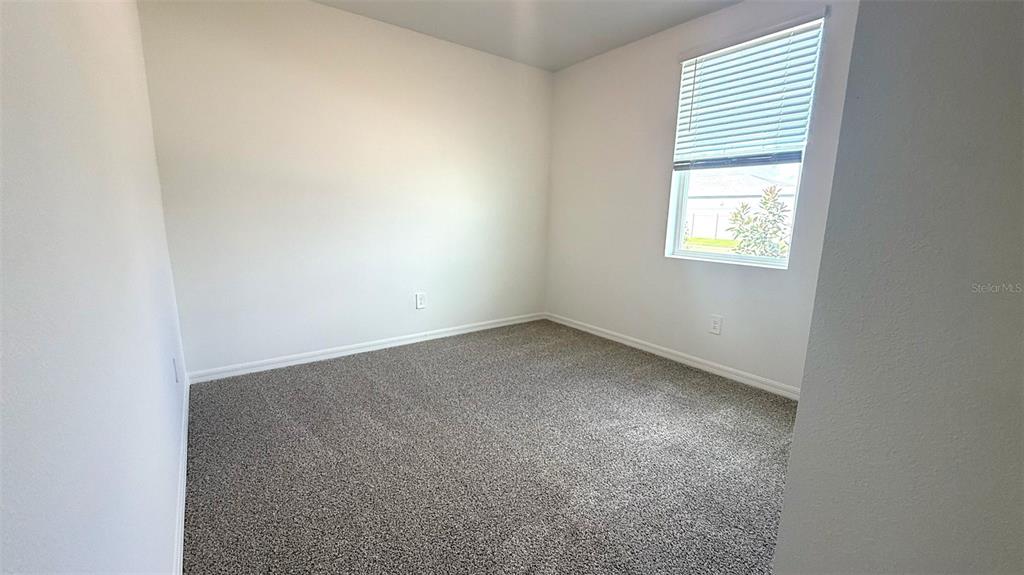 4543 Sidesaddle Trail St. Cloud, FL 34772 - Photo 14 of 19 an empty room with a window