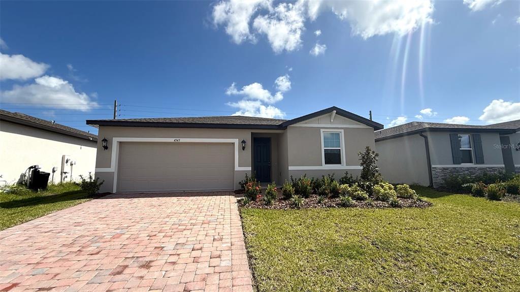 4543 Sidesaddle Trail St. Cloud, FL 34772 - Photo 2 of 19 a front view of a house with garden